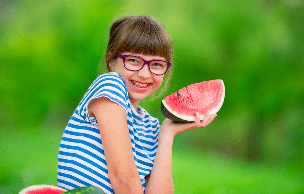 Kid eating a watermelon