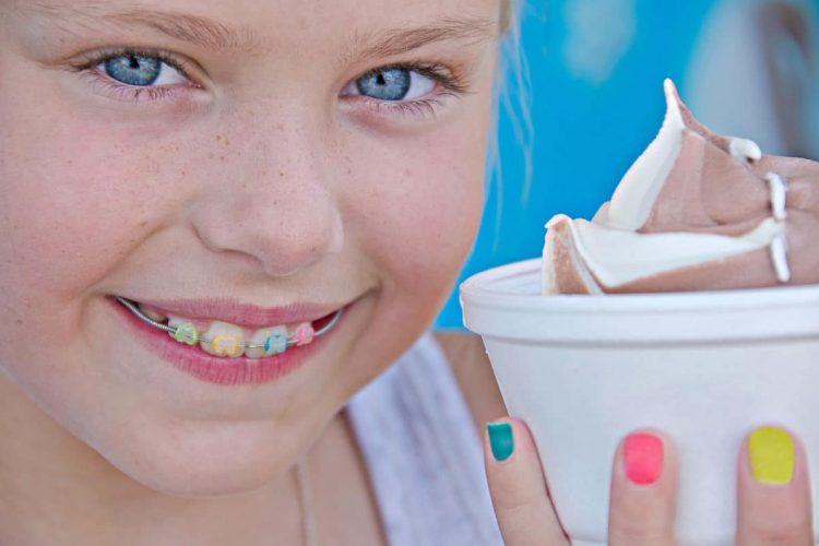 girl smiling with a cup of ice cream