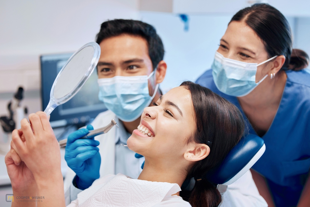 Dental team showing x-ray results to a young patient—explaining diagnosis and how to fix overbite in Tulsa, OK with braces.