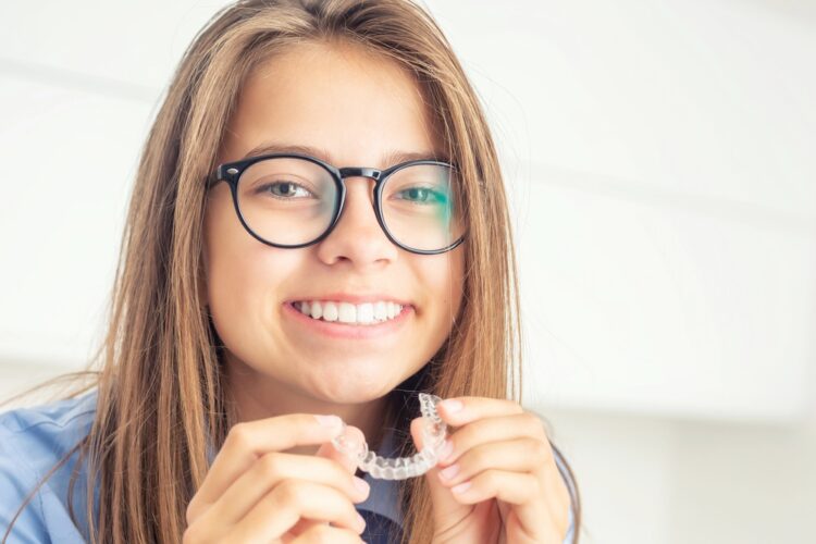 young girl with dental invisalign clean aligners - Can Invisalign Fix Overbite in Tulsa, OK.