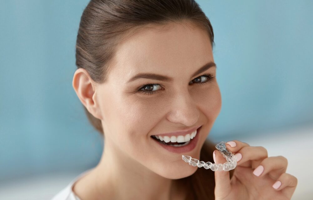 dental care smiling woman using invisalign clear aligners - How Does Invisalign Work in Tulsa, OK